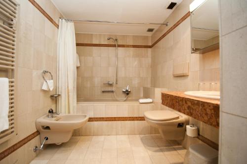 a bathroom with a sink and a toilet and a shower at Albergo Ristorante della Posta in Morcote