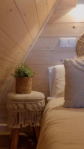 a bedroom with a bed and a table with a plant on it at Casas da Madrinha in Arcos de Valdevez
