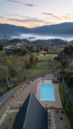 a swimming pool on top of a house at Casas da Madrinha in Arcos de Valdevez