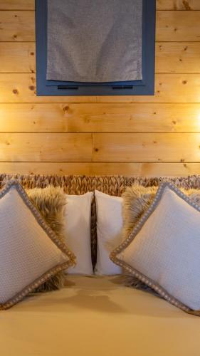 a bed with pillows and a picture on a wall at Casas da Madrinha in Arcos de Valdevez