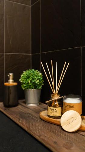 a wooden shelf with someented candles and a plant at Casas da Madrinha in Arcos de Valdevez