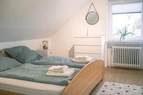 a bedroom with a bed with towels on it at FERIENWOHNUNG "Deichort" Meppen in Meppen