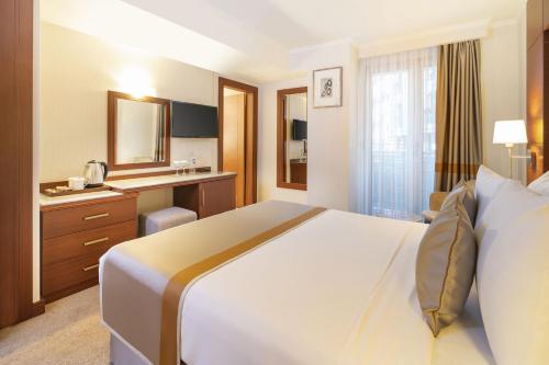 a hotel room with a large bed and a bathroom at Vicenza Hotel Istanbul Old City in Istanbul