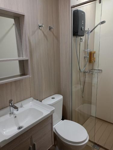 a bathroom with a shower and a toilet and a sink at Homesbyfs Youth City KLIA in Nilai