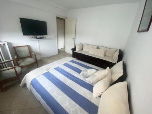- une chambre avec un lit, un canapé et une télévision dans l'établissement Appartement cosy Paris centre Montmartre, à Paris