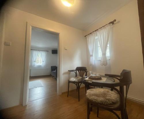 a room with a table and chairs and a dining room at Pension Soutěsky in Hřensko