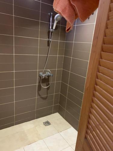 a shower with a hose in a bathroom at Studio liberté 2 in Dakar