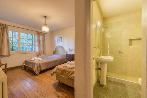 a bathroom with a bed and a sink in a room at La Gaviota in San Carlos de Bariloche