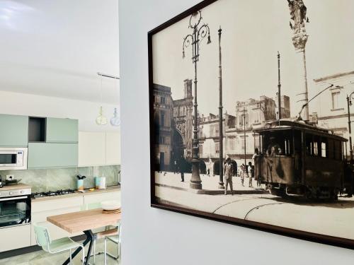 a kitchen with a picture of a train on the wall at MAVÌ in Leverano