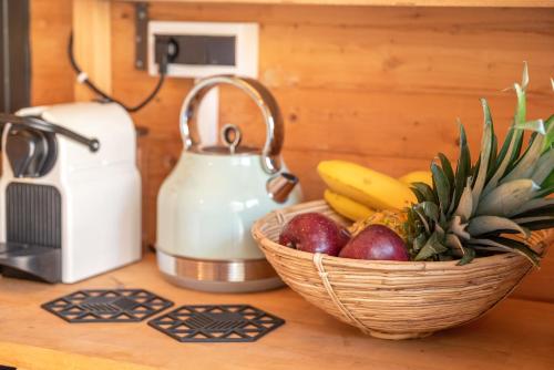 a basket of fruit on a counter next to a blender at Wooden House Apartments in Kaláthenai