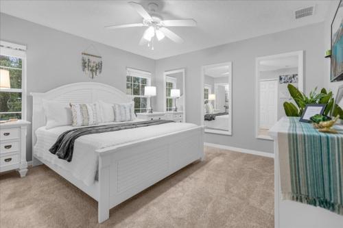 a white bedroom with a bed and a ceiling fan at 4 Bedrooms 3 Bathrooms Terra Verde 4746 Vb in Kissimmee