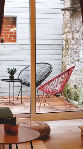 two chairs and a table on a patio at Home Antonin & Maye in Tonnerre