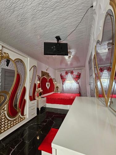 a bedroom with a red bed with hearts on the walls at Dom Aurelia in Świnoujście