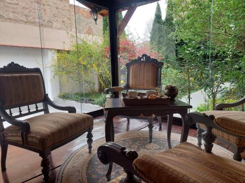 a room with two chairs and a table and a window at Casa Timpuri Vechi in Sibiu