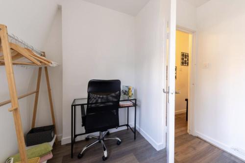 a bedroom with a desk and a chair next to a bunk bed at Private bedroom in London Euston in London