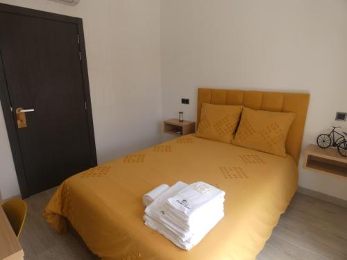 a bedroom with a bed with towels on it at Pinhal Litoral in Marinha Grande