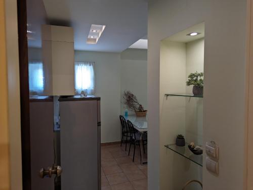 a kitchen and a dining room with a table at HELEN'S ROOMS in Míloi