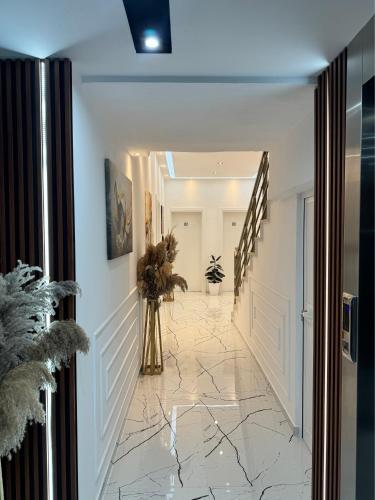 a hallway with a marble floor and white walls at Apartments Costa Azzurra in Velipojë