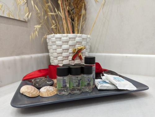 a tray with four bottles of liquids on a table at HELEN'S ROOMS in Míloi