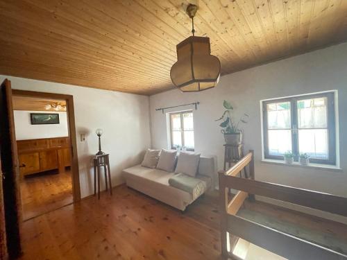 a living room with a couch and a wooden ceiling at Landliebe in Vorchdorf