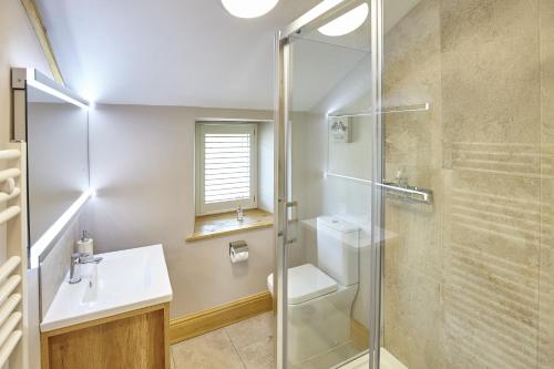 a bathroom with a shower and a sink and a toilet at Cumbria, en-suite bathrooms, North Pennines in Alston