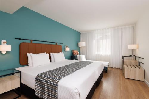ウィーンにあるエグゼ ウィーンの青い壁のベッドルーム1室(大型ベッド1台付)