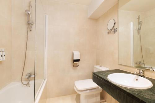 a bathroom with a sink and a toilet and a shower at Exe Vienna in Vienna