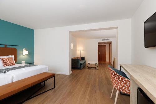 a bedroom with a bed and a living room at Exe Vienna in Vienna
