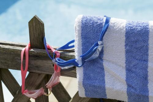 a towel is hanging on a wooden fence at Rectory Manor in Lavenham