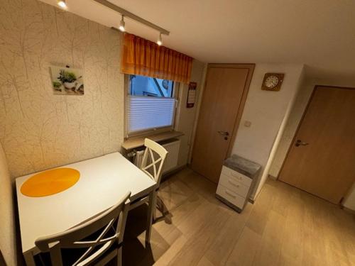 a small room with a table and chairs and a window at Ferienwohnung Laurentius in Rennerod