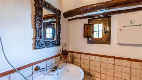 a bathroom with a sink and a mirror at Molino Los Justos - Casa Vieja- Algarinejo by Ruralidays in Algarinejo