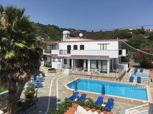 a villa with a swimming pool and a resort at Adult Only - Hotel Suzanna in Achladies