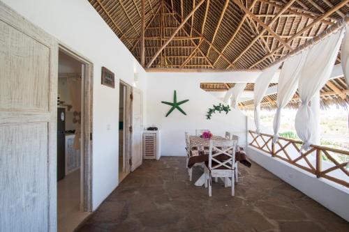 a hallway of a house with a table and chairs at Rafiki Tamu Residential Resort in Watamu