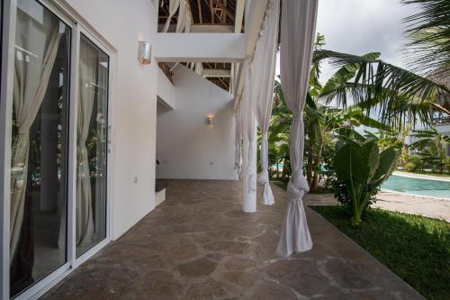 a hallway of a house with white umbrellas at Rafiki Tamu Residential Resort in Watamu