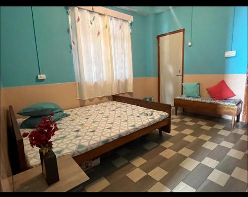Un dormitorio con 2 camas y una mesa con un jarrón. en Teesta Inn en Gangtok