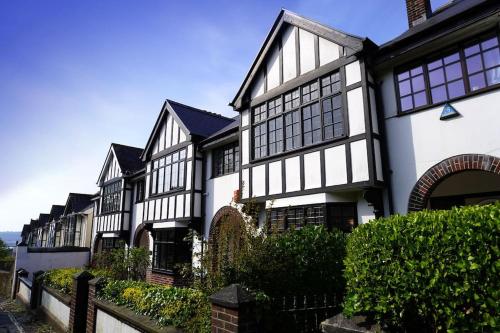 a row of black and white houses at Central City Centre 3 bedroom home Private Parking in Plymouth