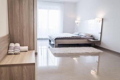 um quarto branco com 2 camas e um espelho em Hotel Rođo em Teslic