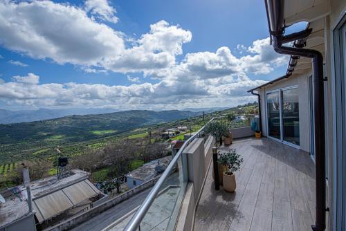 a balcony of a house with a view of the mountains at Nikola's endless view in Stíronas