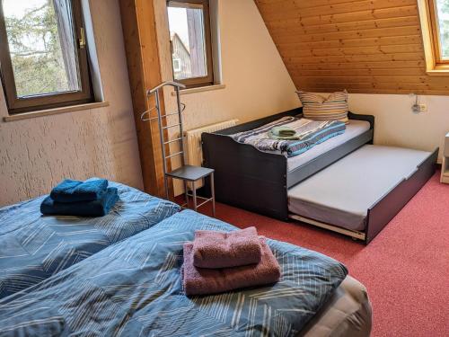 a bedroom with two beds and a chair at Ferienwohnung Dresden Nickern in Dresden