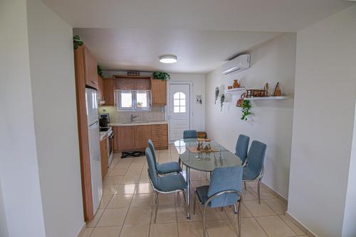 a kitchen and dining room with a table and chairs at Nikola's endless view in Stíronas