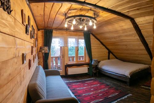 a bedroom with a couch and a bed in a room at Ранчо Скарбова Гора in Selisko