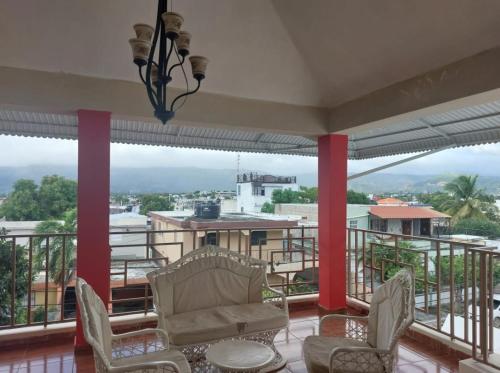 a balcony with chairs and a view of the city at New apartment close to everything in Santiago de los Caballeros