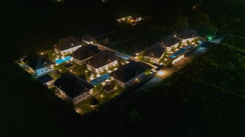 an aerial view of a mansion at night at Rafiki Tamu Residential Resort in Watamu