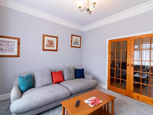 a living room with a couch and a table at Church View - Pass the Keys in Ferryhill