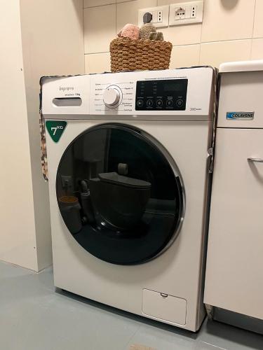 a washing machine with a bowl inside of it at Ornella's apartment - Relax near Venice in Boion