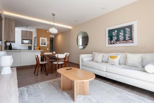 a living room with a white couch and a table at Magnific 2BR in Cuauhtemoc in Mexico City