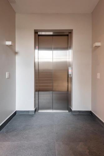 a elevator with a metal door in a building at Magnific 2BR in Cuauhtemoc in Mexico City