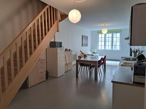 a kitchen with a staircase and a table in a room at Appartement proche centre ville et sur les remparts in Langres