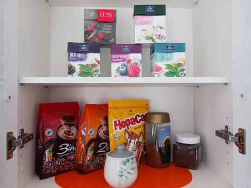 a shelf with snacks and other items on it at Kandavas Apartments in Daugavpils