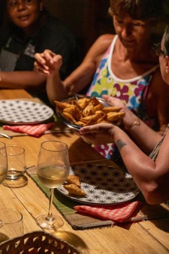 a group of people sitting at a table with a plate of food at Rafiki Tamu Residential Resort in Watamu